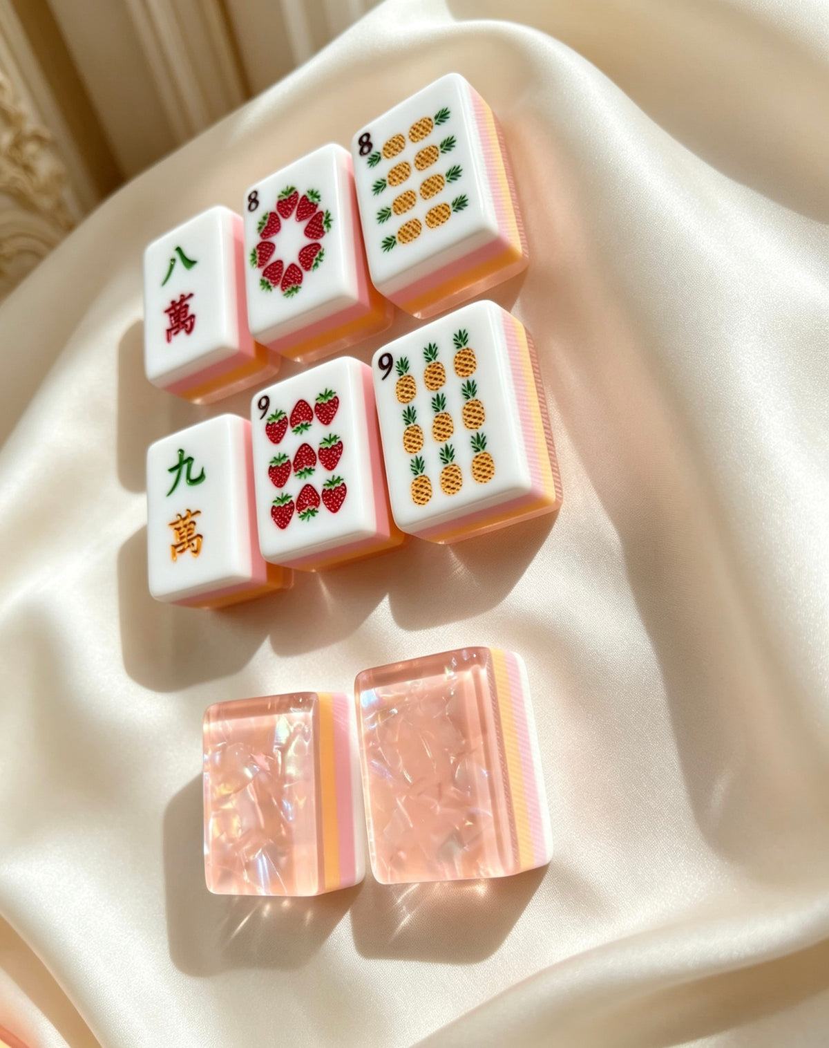 MAHORA Fruity Sparkle: Fruit suit tiles and peach backs on folded cream fabric