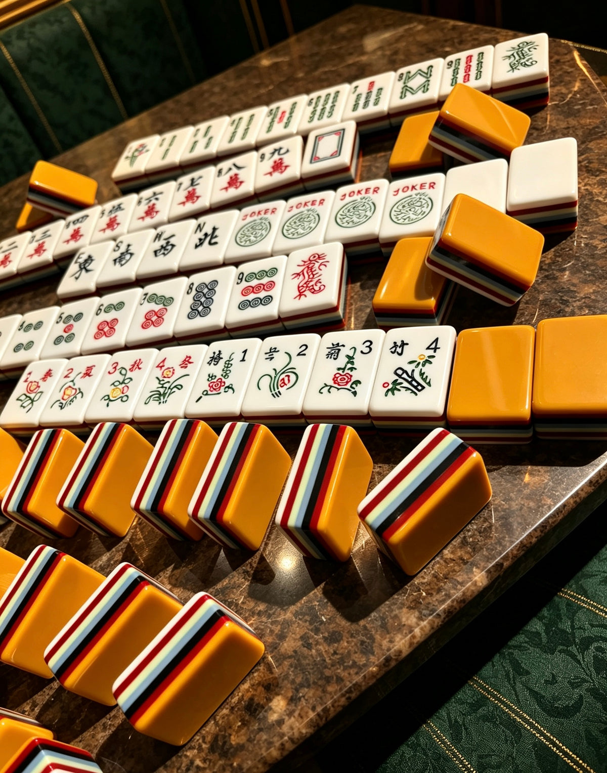 MAHORA 7-Layer: Orange tile backs beside rows of traditional faces
