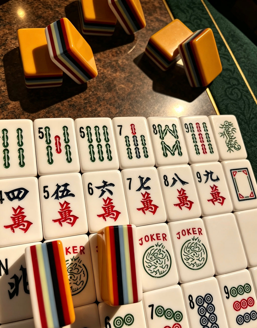 MAHORA 7-Layer: Bamboo and character faces beside stacked orange tiles
