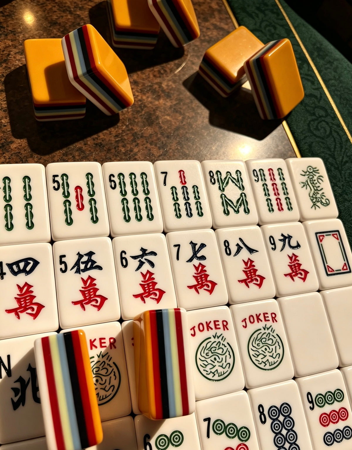 MAHORA 7-Layer: Bamboo and character faces beside stacked orange tiles