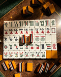 MAHORA 7-Layer: Traditional tile faces and orange backs on a dark table