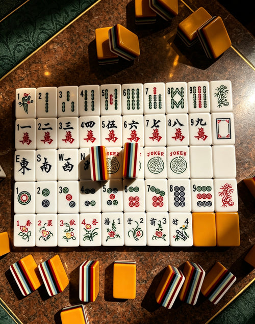MAHORA 7-Layer: Traditional tile faces and orange backs on a dark table