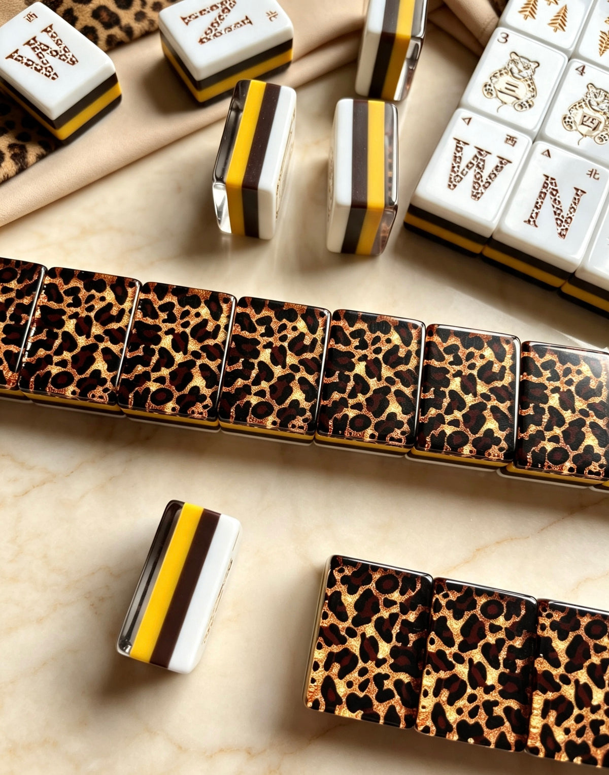 MAHORA Leopard Print: Close-up of gold-toned, white and dark acrylic layers