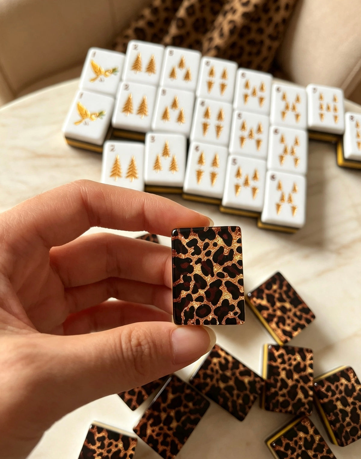 MAHORA Leopard Print: Hand holding a leopard-pattern tile in front of displayed faces