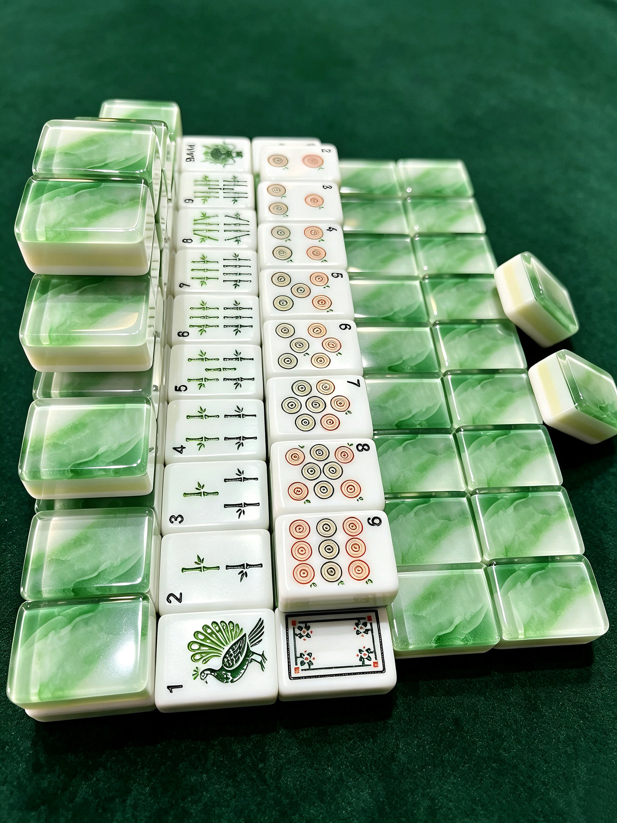 MAHORA Emerald: Top view of green backs and illustrated tile faces