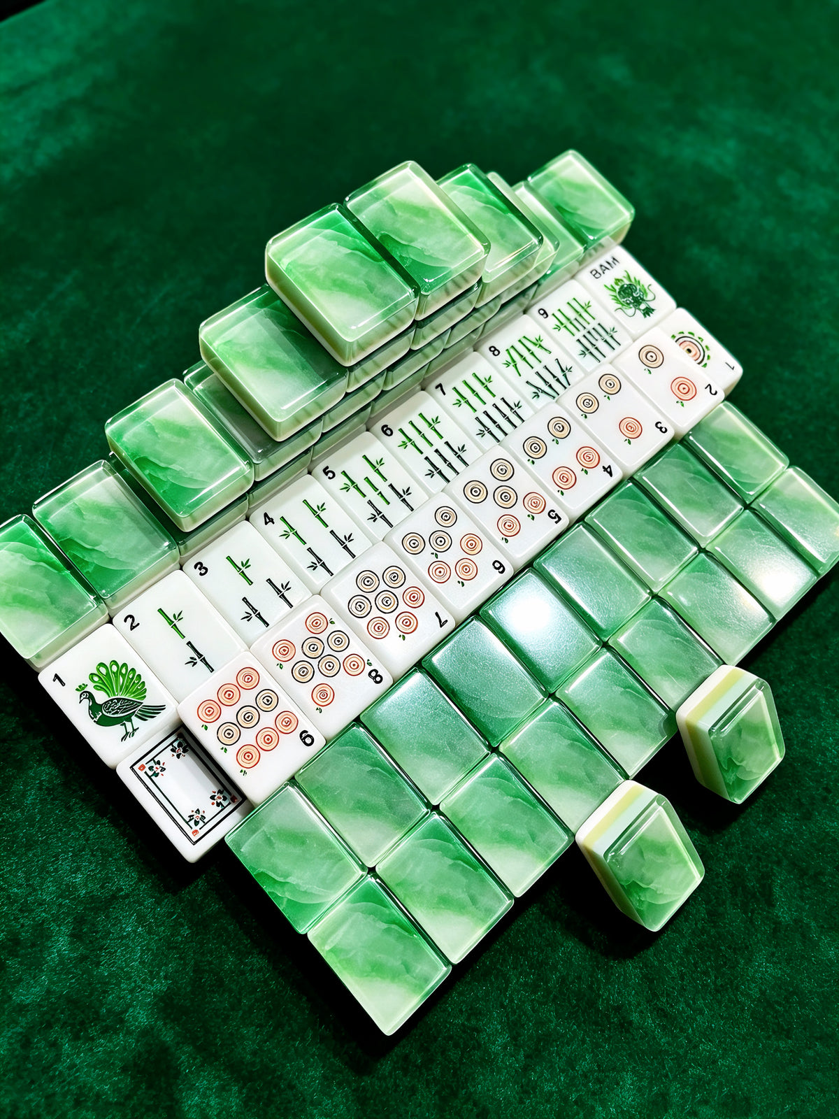 MAHORA Emerald: Angled view of green tile backs and arranged suits