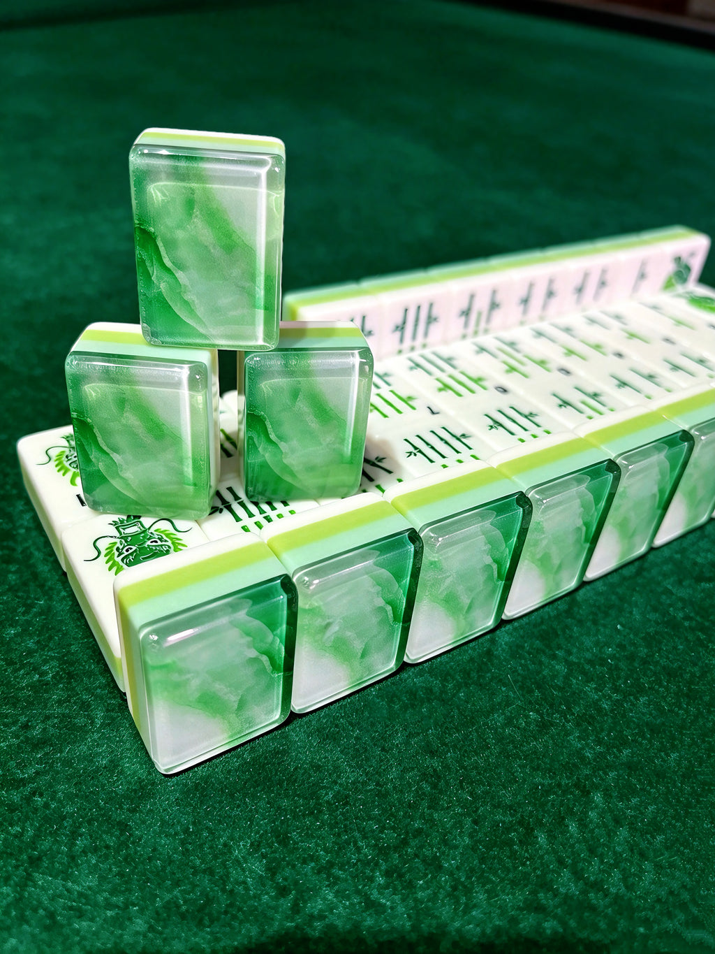 MAHORA Emerald: Stacked green tiles showing layered sides and marbled backs