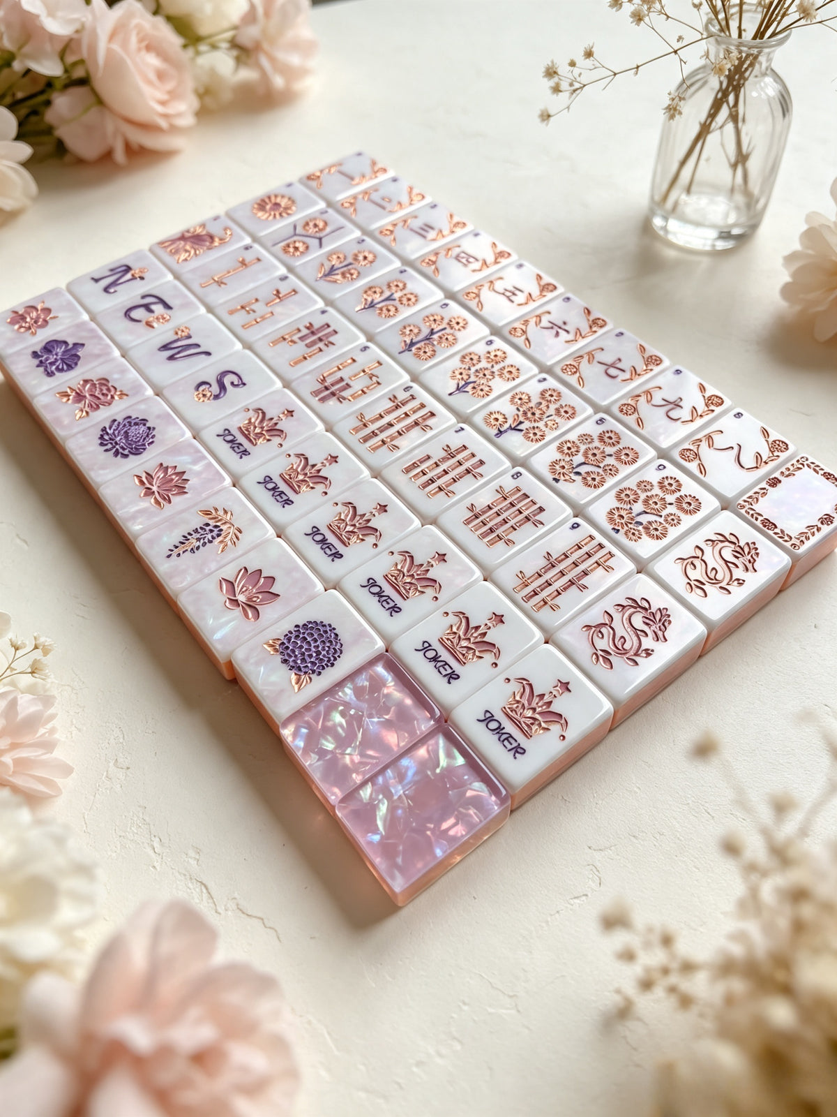 MAHORA Frost Lilac: Tile faces arranged in rows beside a vase of flowers