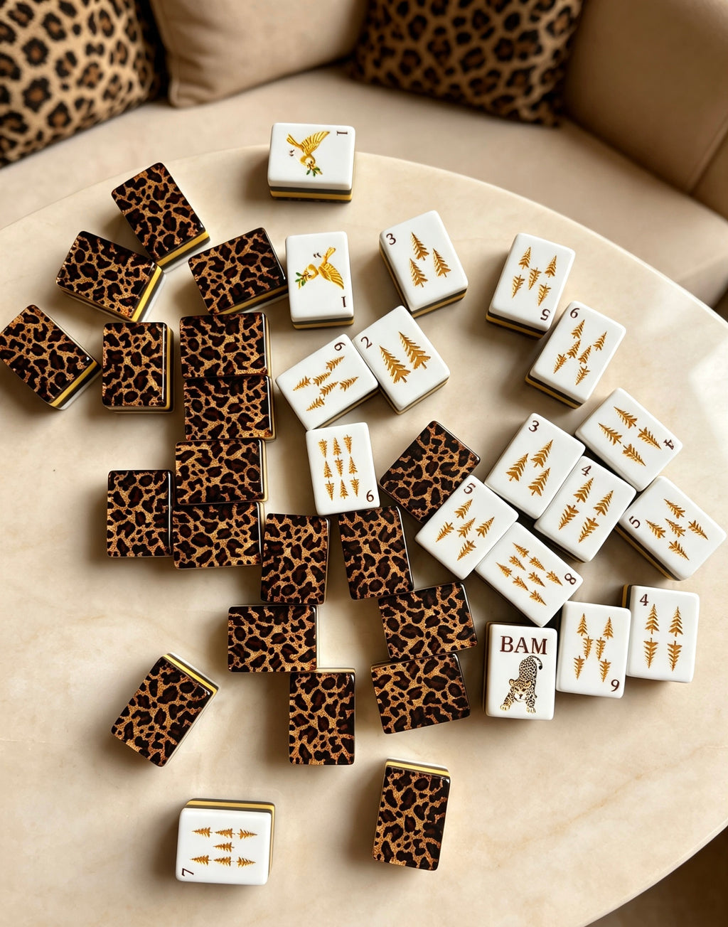 MAHORA Leopard Print: White tile faces and leopard-pattern backs scattered on a cream table